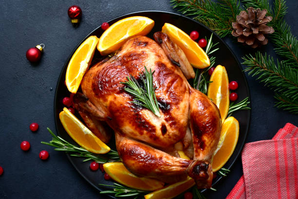 istock Roasted christmas chicken with oranges ,rosemary and cranberries 1343910720