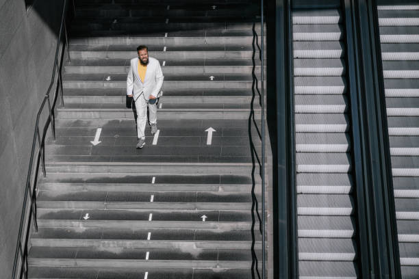 istock Businessman walk down the staircase 1343911918