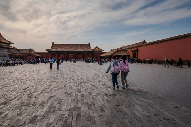 Beijing, China -- April 3, 2016. A wide angle photo at the top level of the Forbidden City where tourists are walking around.