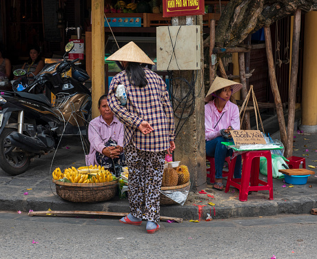 Hon Gai, Vietnam -- March 23, 2016.  photo of  street merchants on a busy shopping street in Hongai, Vietnam.