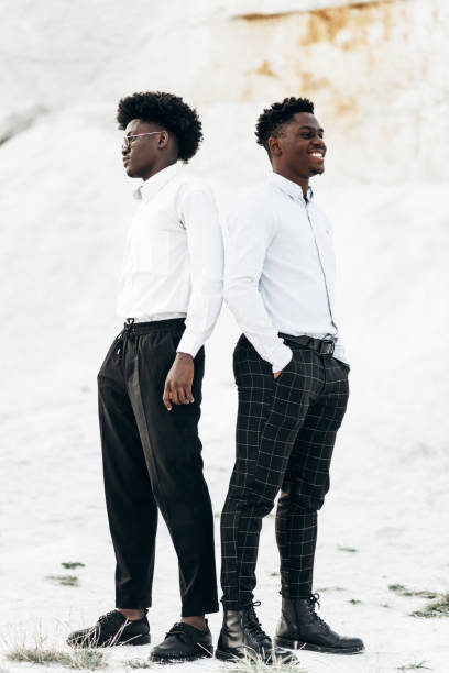 istock Two trendy American men posing back to back against the backdrop of white mountains 1343918421