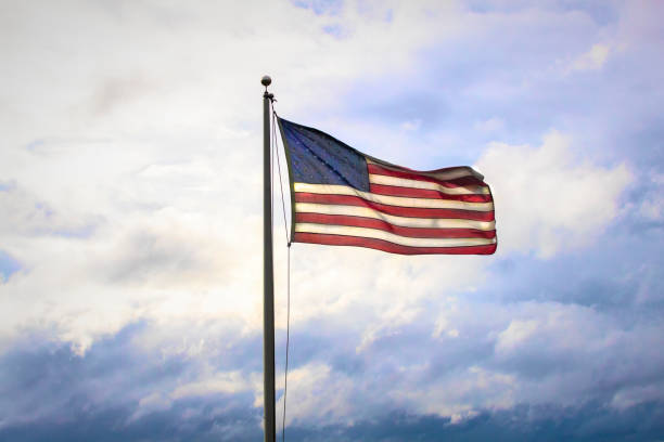 istock American Flag  against  Sky and Clouds 1343924713