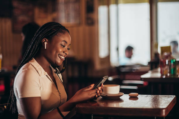 istock African american woman using smartphone while in a cafe 1343926156