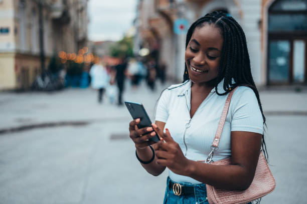 istock frican american woman using smartphone while out in the city 1343926205