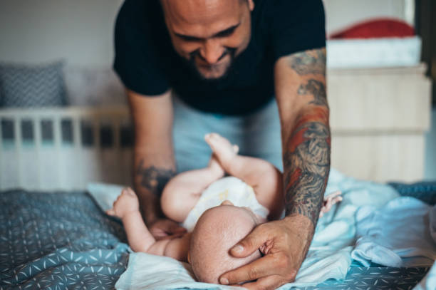 istock Tattooed bearded father playing with his son 1343926221