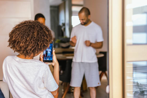 istock Father and daughter dance while son takes pictures 1343927709