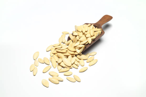 istock Pumpkin seeds on a white background, isolated. Top view, pumpkin seeds background 1343930332