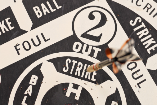 Top perspective of a dart hitting the STRIKE section of a baseball style dart game