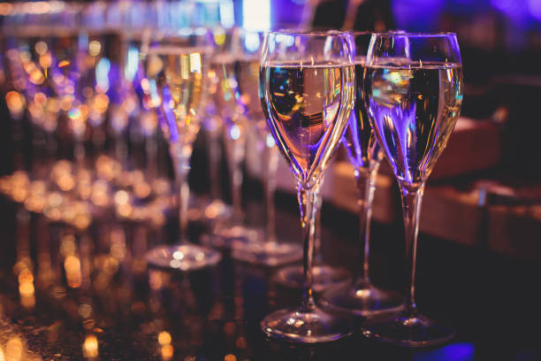 istock Line of alcohol setting on catering banquet table, bartender pouring beverages, row of different colored alcohol cocktails on a party, martini, vodka, and others on decorated banquet table event 1343933552