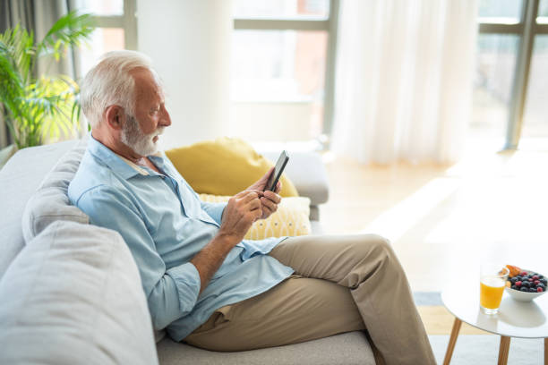 istock Happy senior man using social media on his phone at home. 1343960814