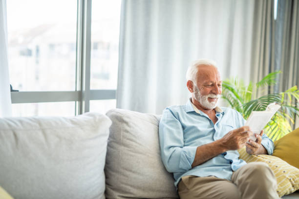 istock Senior man reading a book at home. 1343962075