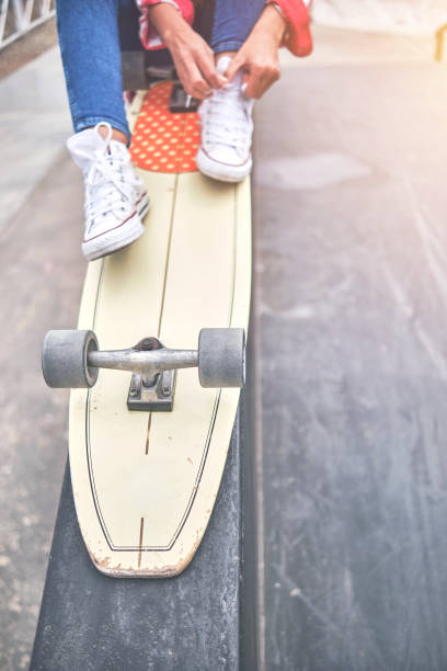 istock Skater girl getting ready for action, tying shoestring. First step. Selective focus 1343964828