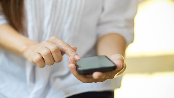 istock Woman's hands hold cellphone, using calculator app on mobile phone 1343964844