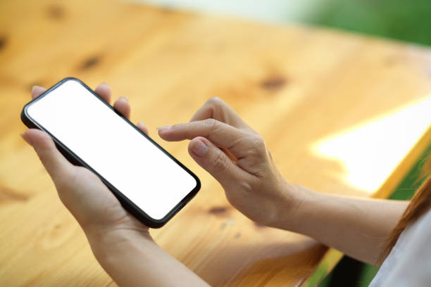 istock Smartphone blank screen mockup for montage hold by young female 1343964862