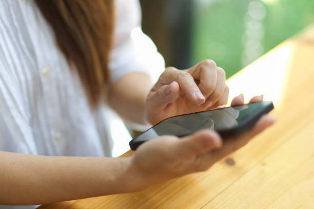 istock Female sits at desk, using smart mobile phone for message 1343964863
