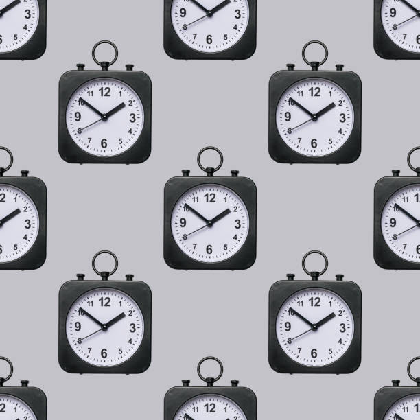 istock Seamless pattern of classic watches with hands on a gray background. 1343970871