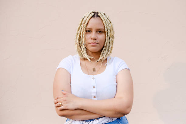istock Beautiful model with afro braids with crossed arm looking at camera. 1343974393