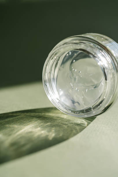 istock Transparent gel in a jar on a green background. 1343982459