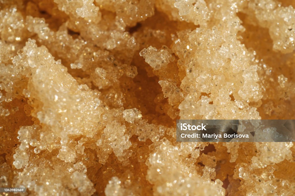The texture of a shining scrub close-up. The texture of a shining sugar scrub close-up. Perfect for showcasing the texture of your product. Exfoliation Stock Photo