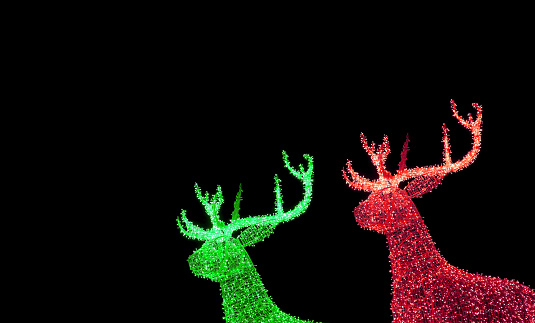 Vivid Green and Red Illuminated Christmas Reindeer Shaped Outdoor Decoration Lights on Night Sky Background