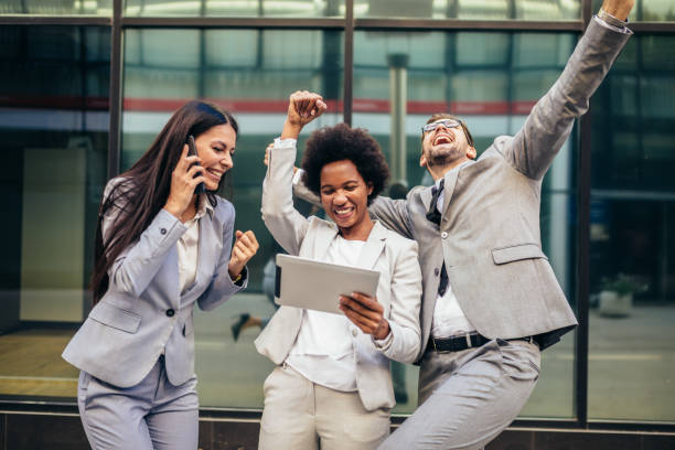 istock Business team celebrating a triumph, looking at digital tablet. 1343996127