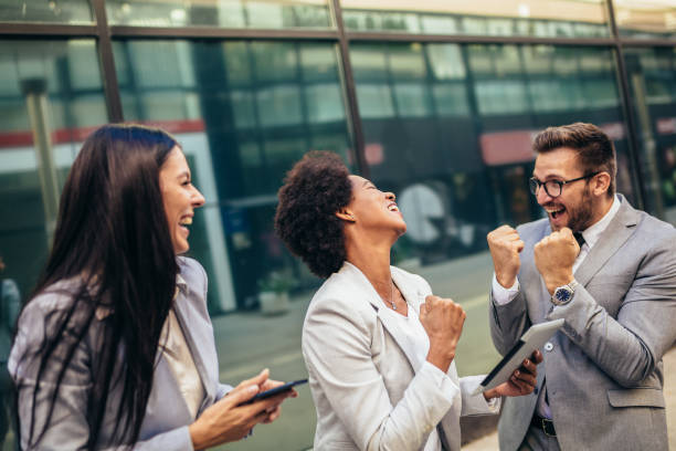 istock Business team celebrating a triumph, looking at digital tablet. 1343996173
