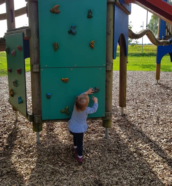 istock Girl wants to climb high climbing wall 1343996501