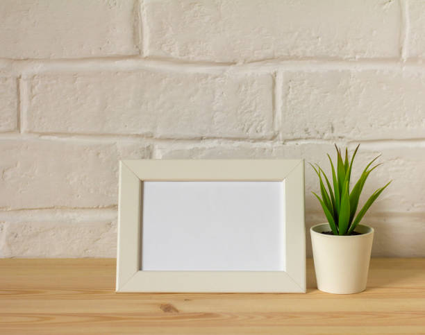 istock An empty photo frame on a table or shelf with a copy of the space. 1343997373