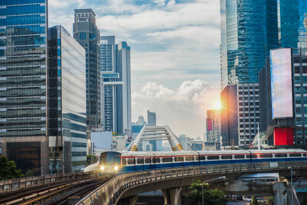 Electric train, running on the way with business office buildings on the background. BTS Skytrain, Electric train, running on the way with business office buildings on the background. bts skytrain stock pictures, royalty-free photos & images