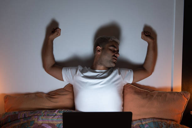 istock Hispanic man stretching out in front of laptop 1344000519