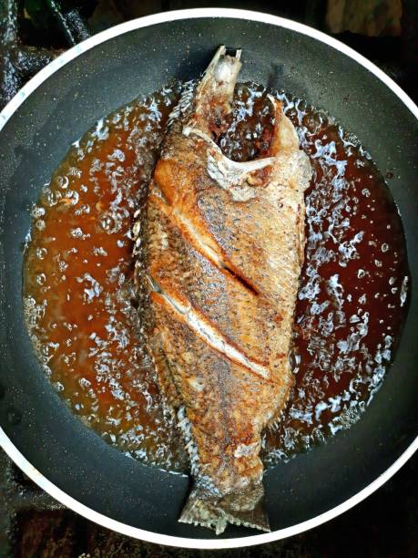istock Frying Seabass fish in boiling cooking oil. 1344001644