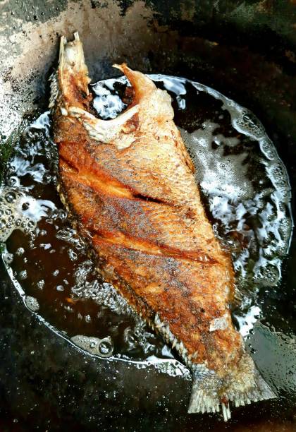 istock Frying Seabass fish in boiling cooking oil. 1344001655