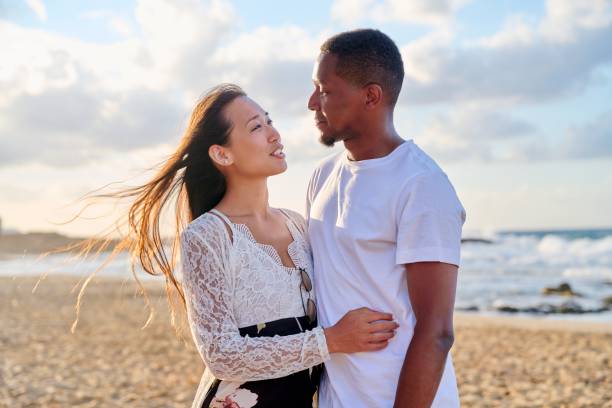 istock Loving romantic hugging young multiethnic couple on the seashore 1344002267