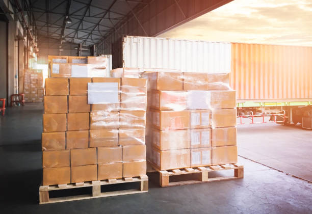 istock Stacked of Package Boxes on Pallets Loading with Shipping Cargo Container. Truck Parked Loading at Dock Warehouse. Delivery. Warehouse Logistics. Cargo Freight Truck Transportation. 1344003527