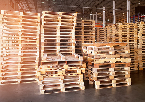 Yellow wooden pallets in supermarket warehouse