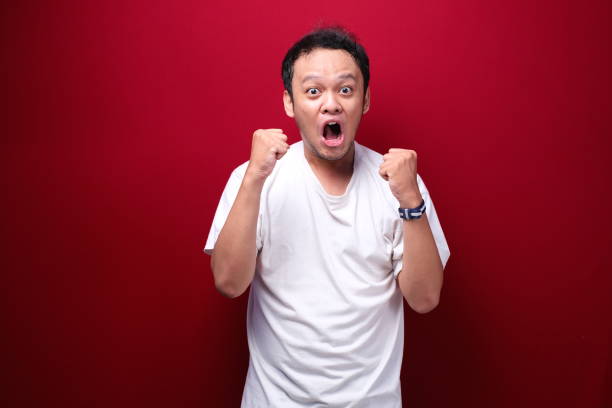 istock Angry and stress young Asian man raising his arm up. 1344005207