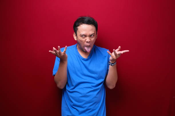 istock Angry and stress young Asian man raising his arm up. 1344005209