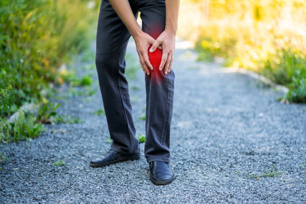 istock Knee pain when walking outdoors, man with jogging injury 1344006449