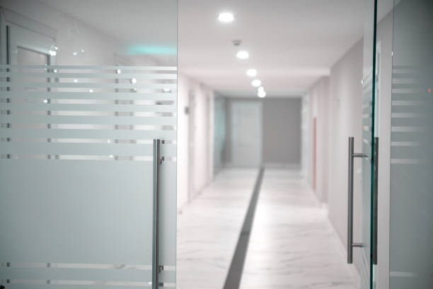 White office corridor with glass door.