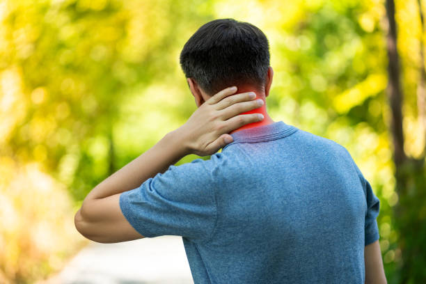 istock Neck pain when walking outdoors, man with backache on nature background 1344008790