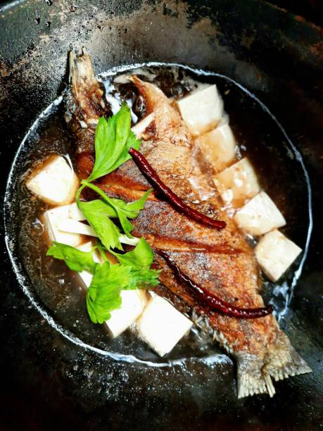 istock Deep fried Seabass fish with tofu and celery  vegetable in brown sauce. 1344008950