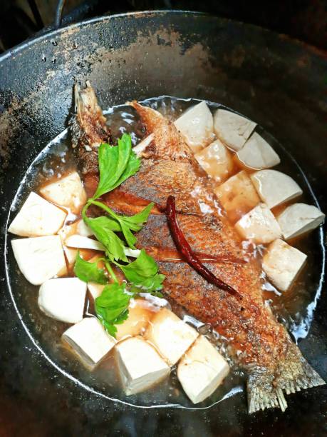 istock Deep fried Seabass fish with tofu and celery  vegetable in brown sauce. 1344008952