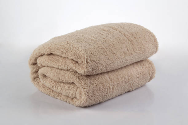 istock Soft and warm of brown folded blanket isolated on white 1344009623