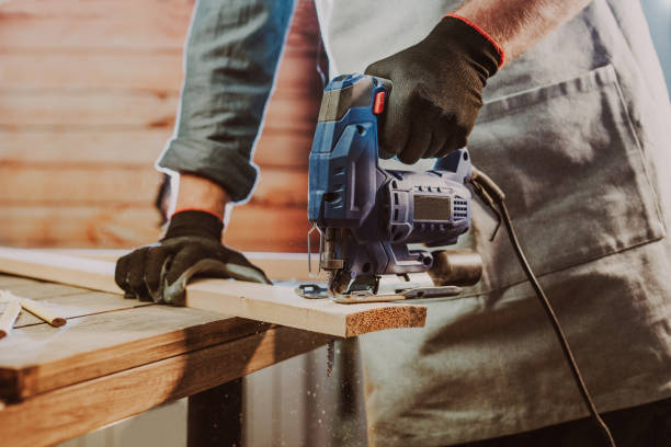 istock Close up of worker using electric jigsaw in the workshop 1344010638