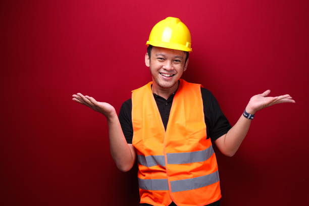 istock Young Asian Man worker is happy and smiling with open hand gesture 1344010663