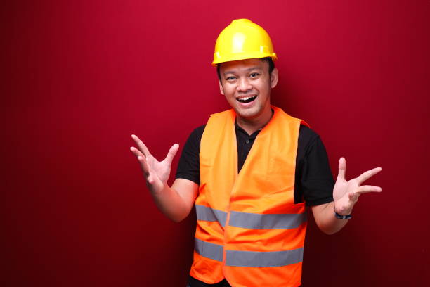 istock Young Asian Man worker is happy and smiling with open hand gesture 1344010667