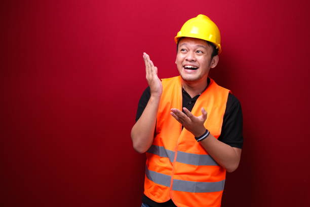 istock Smile and happy young asian man worker is with with hand point on empty space 1344010747
