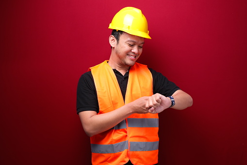 Happy Young asian man workers when see watch