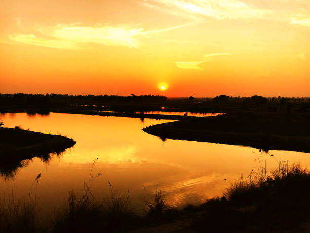 istock beautiful orange sad evening sunset over the river landscape 1344012184