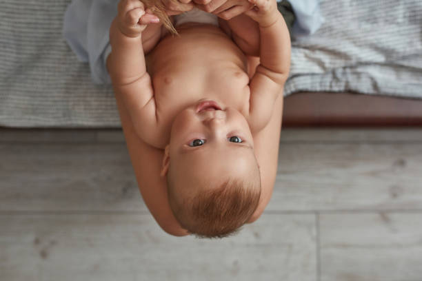 istock Excited little baby on knees, looking up 1344012185